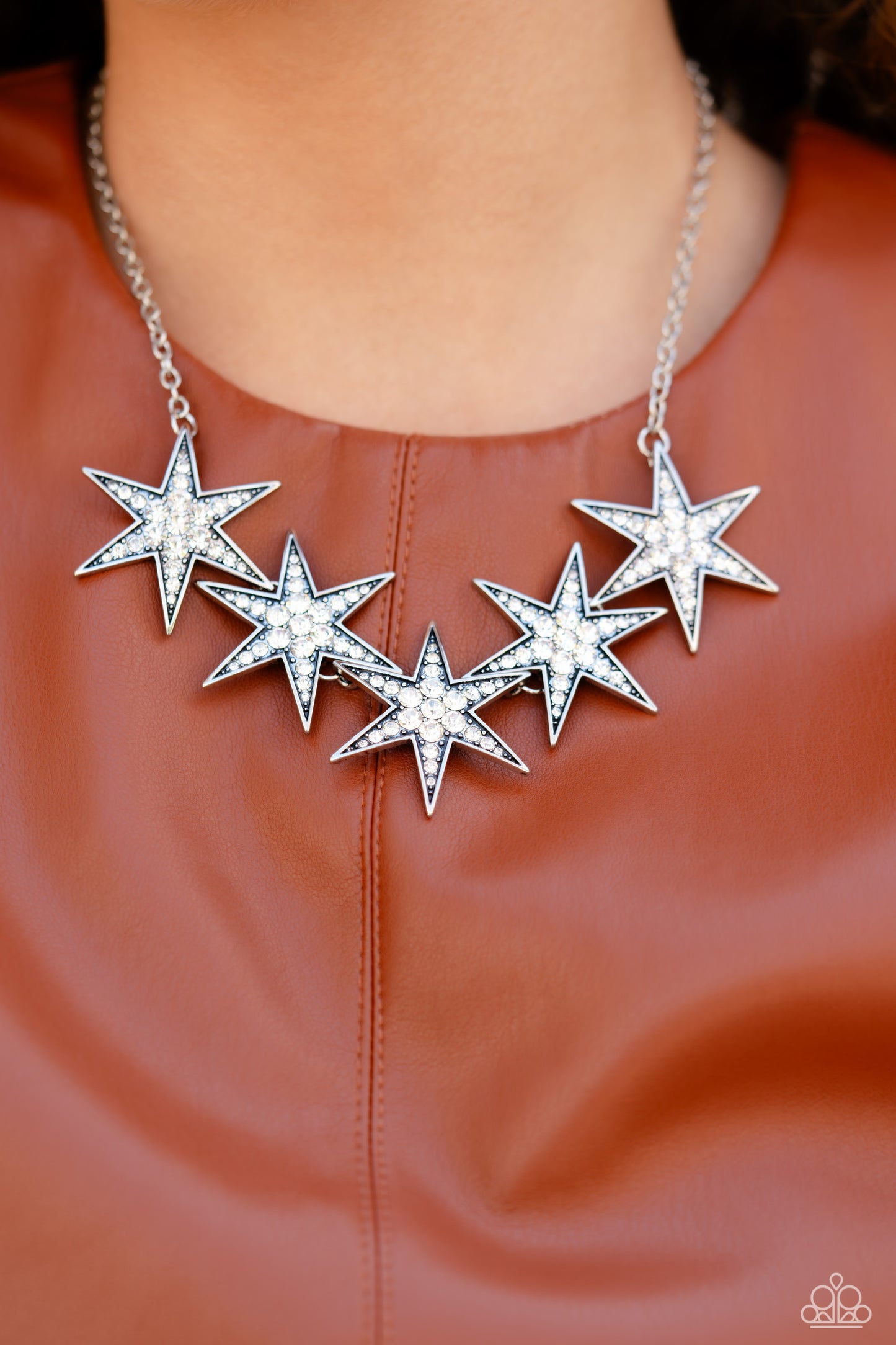 Paparazzi Accessories Rockstar Ready - White Dotted with various sizes of highly reflective white rhinestones, a stellar collection of 3D silver stars interlock from a dainty silver link chain for an out-of-this-world edgy fashion. Features an adjustable