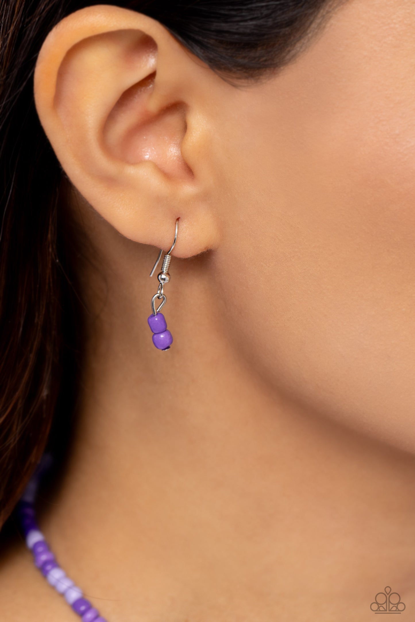 Paparazzi Accessories Pearly Possession - Purple Infused along an invisible string, lavender, plum, and purple seed beads combine with sporadically placed purple discs, and glossy white and heart-shaped pearls for a vibrant pop of color along the neckline