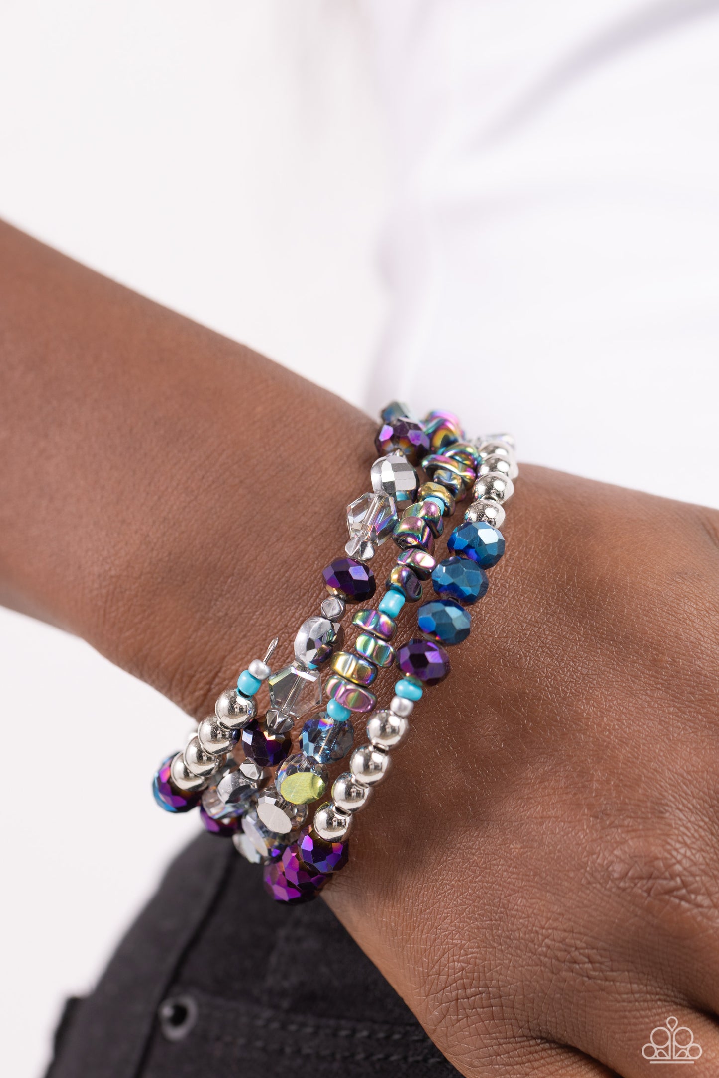 Paparazzi Accessories Impressive Infinity - Multi Sections of shiny silver beads, oil spill pebbles, clear iridescent faceted discs, turquoise beads, and an alternating pattern of blue and purple oil spill-coated beads are infused along a coiled wire, cre