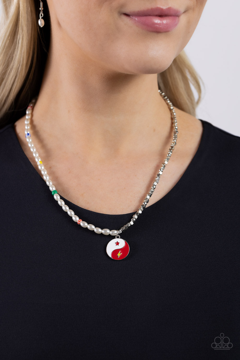 Paparazzi Accessories Youthful Yin and Yang - Red A strand of oval white pearls, sporadically infused with multicolored-striped beads, collides with cubed silver beads and studs to create an abstract blend of elegance and sheen. A yin-yang charm featuring