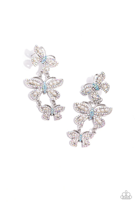 Paparazzi Accessories Fluttering Finale - Multi An airy trio of silver butterflies of various sizes link into a whimsical lure. Each butterfly's wings have been dipped in iridescent rhinestones and white pearls, while the bodies are dipped in blue iridesc