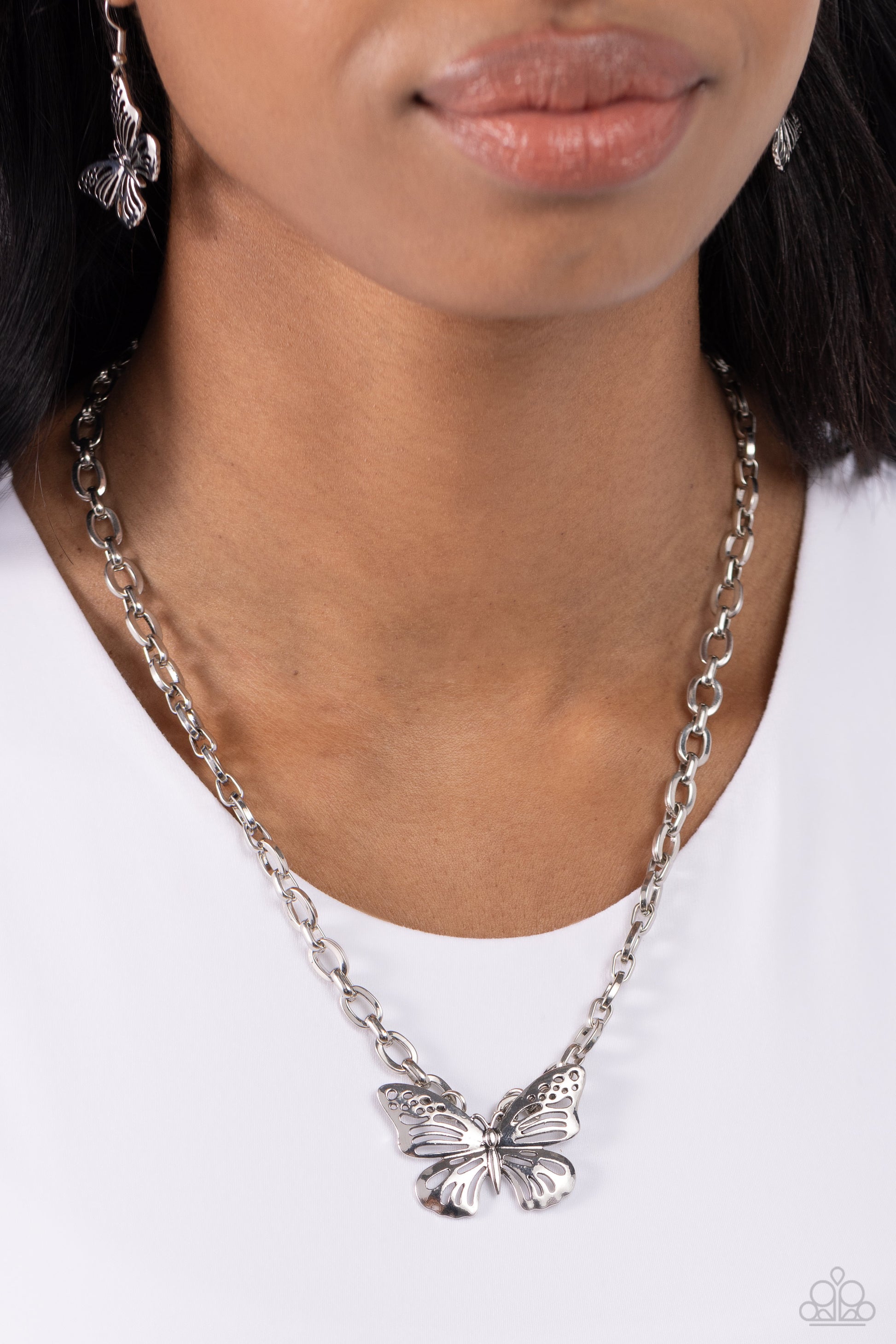 Paparazzi Accessories Midair Monochromatic - Silver Featuring airy cutout details, a high-sheen silver butterfly is connected to the bottom of a thick silver link chain for a whimsically monochromatic statement. Features an adjustable clasp closure. Sold
