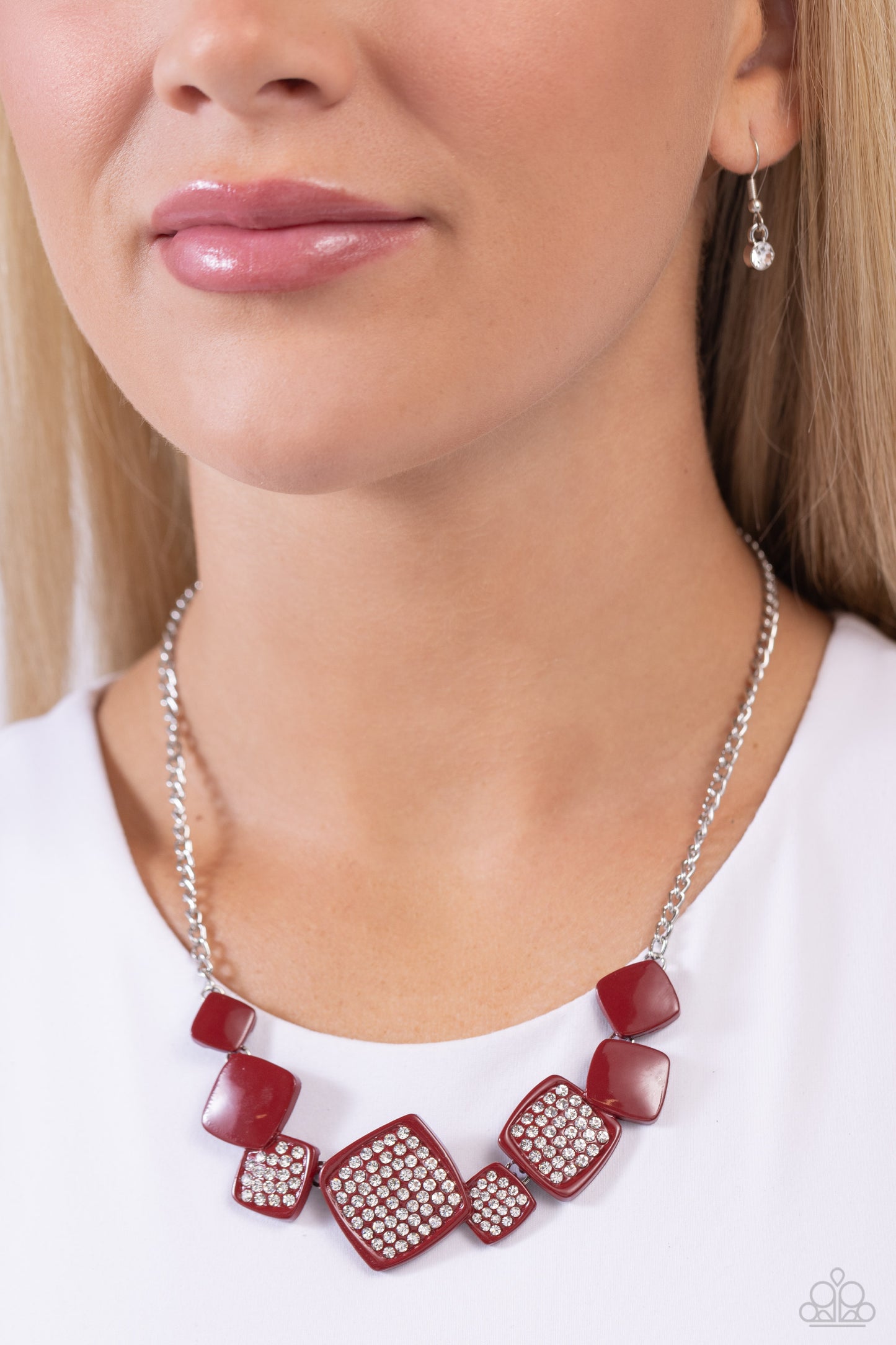 Paparazzi Accessories Twinkling Tables - Red Infused along a classic silver chain, tilted, glossy, wine-painted squares lead the eye to rhinestone-embossed wine-painted squares that alternate in size, creating a standout statement below the collar. Featur