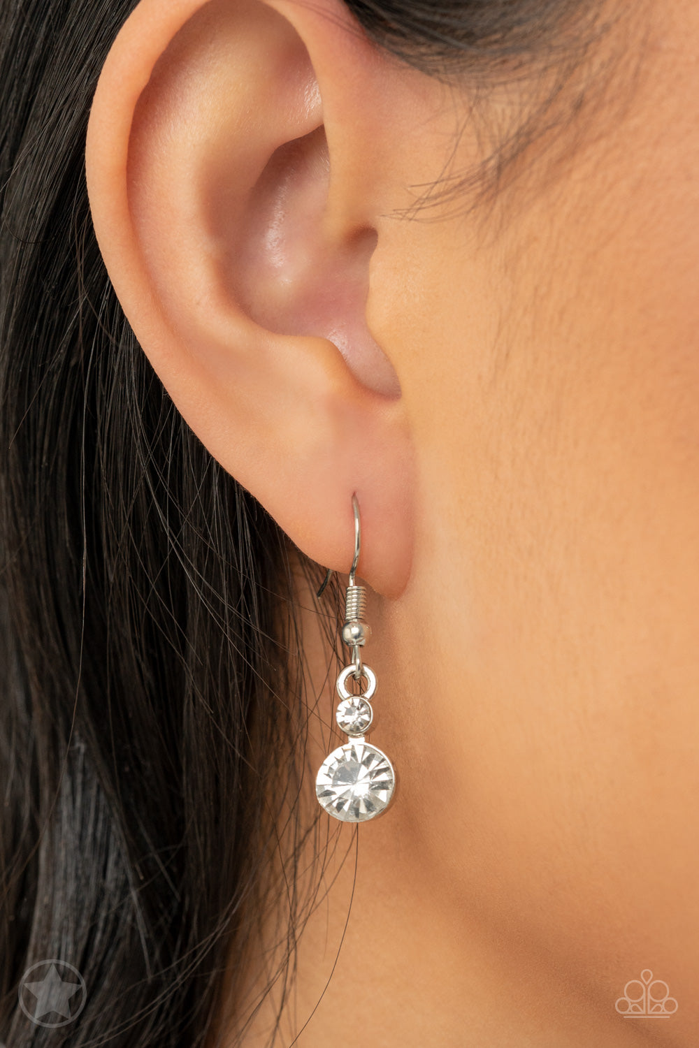 Paparazzi Accessories Hollywood Hills - White A row of dazzling white rhinestones drapes along the neckline, creating a sparkling display. Daintier white rhinestones are sprinkled along the clusters, adding luminous detail to the timeless design. Features
