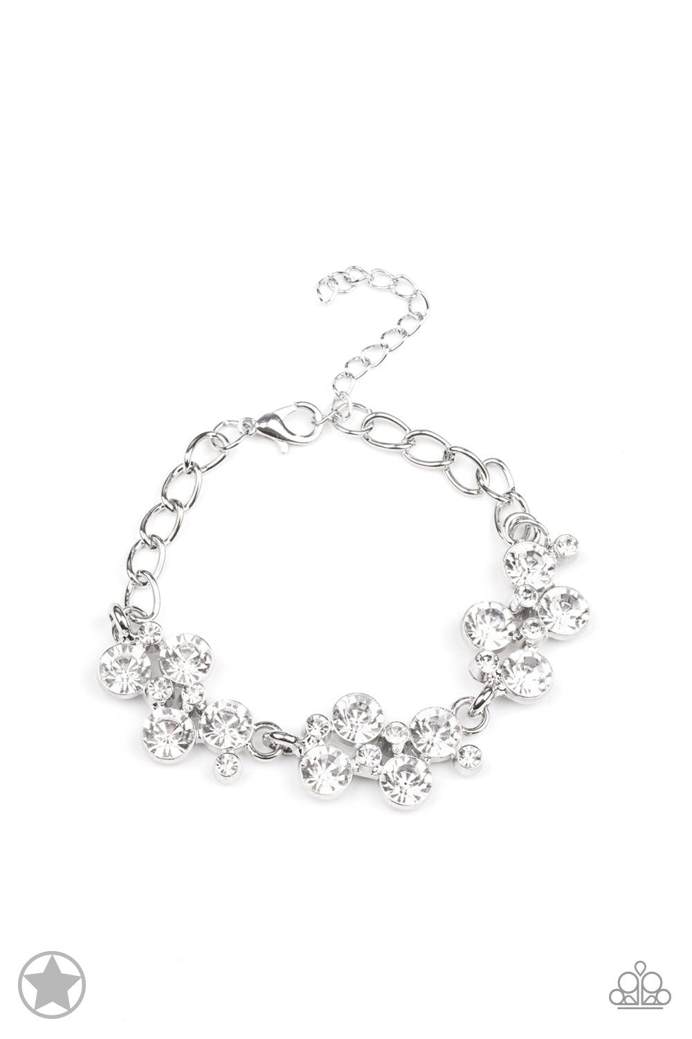 Paparazzi Accessories Old Hollywood Clusters of brilliant white rhinestones drape elegantly along the wrist. The scattered pattern and varying sizes of the rhinestones add breathtaking detail to the piece. Features an adjustable clasp closure. Sold as one