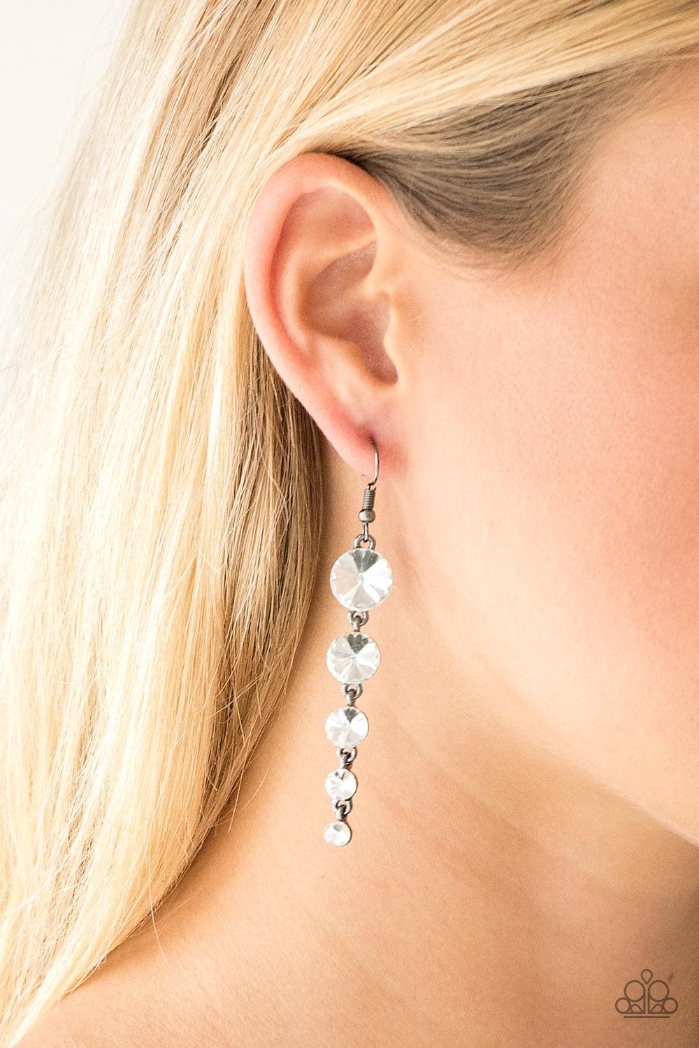 Paparazzi Accessories Raining Rhinestones - Black Gradually decreasing in size, glassy white rhinestones trickle from the ear, coalescing into a glamorous lure. Earring attaches to a standard fishhook fitting. Sold as one pair of earrings. Jewelry