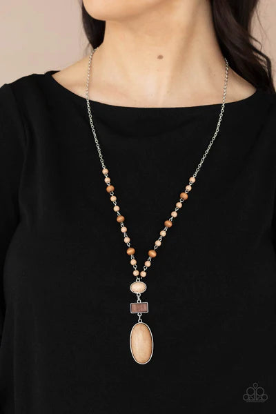 Paparazzi Accessories Naturally Essential - Brown A dainty collection of Desert Mist stones and rustic wooden beads connect into an earthy chain across the chest. Featuring sleek silver frames, oval Desert Mist stones and a rectangular wooden frame connec