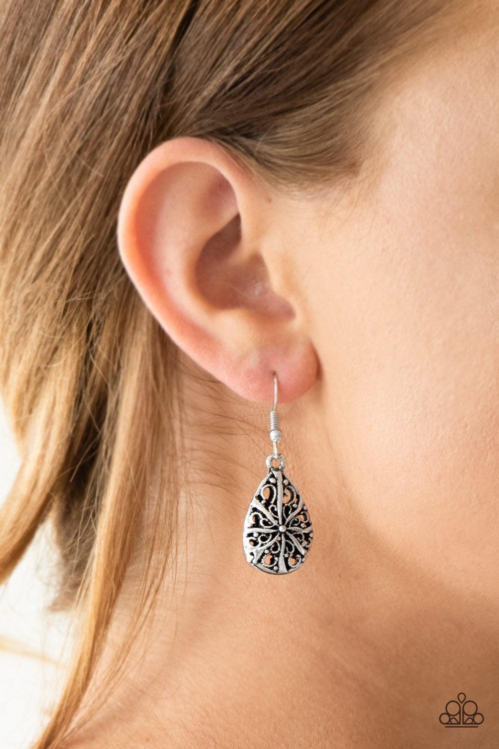 Paparazzi Accessories Western Wisteria ~Silver Brushed in an antiqued finish, shimmery silver filigree joins into a dainty teardrop frame for a whimsical look. Earring attaches to a standard fishhook fitting. Sold as one pair of earrings.