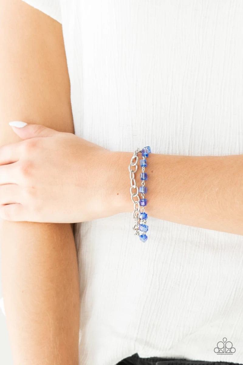 Paparazzi Accessories Life Of The Block Party - Blue A strand of iridescent blue crystal-like cube beading joins a classic strand of silver chain around the wrist, creating refined layers. Features an adjustable clasp closure. Sold as one individual brace