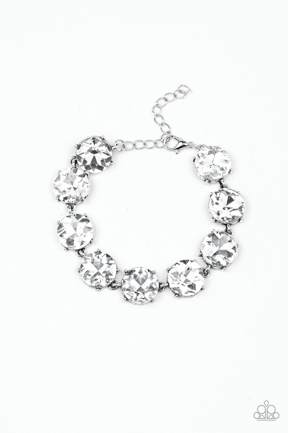 Paparazzi Accessories Fabulously Flashy - White Nestled inside classic silver fittings, a collection of oversized white rhinestones delicately link around the wrist for a flashy finish. Features an adjustable clasp closure. Sold as one individual bracelet