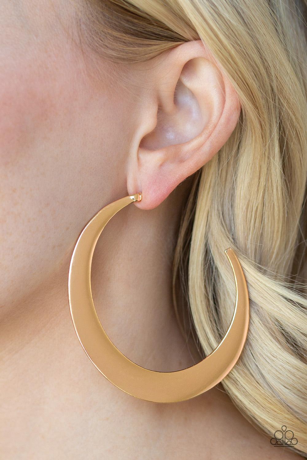Paparazzi Accessories Moon Beam - Gold Brushed in a high-sheen finish, a flat gold hoop curls into a bold crescent-like shape for an edgy look. Earring attaches to a standard post fitting. Hoop measures approximately 2 1/2" in diameter. Jewelry