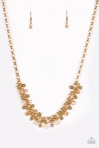 Paparazzi Accessories Trust Fund Baby - Gold Dipped into a golden metallic shimmer, faceted white beads and classic gold beads swing from interlocking gold chains, creating a refined fringe below the collar. Features an adjustable clasp closure. Sold as o