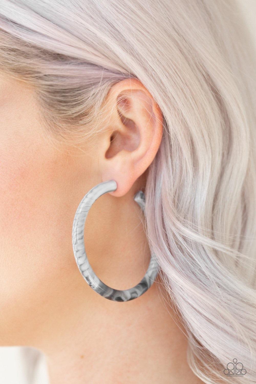 Paparazzi Accessories Miami Minimalist - White Brushed in a smoky faux marble finish, a shiny white hoop curls around the ear for a retro look. Earring attaches to a standard post fitting. Hoop measures 2 1/2" in diameter. Sold as one pair of hoop earring