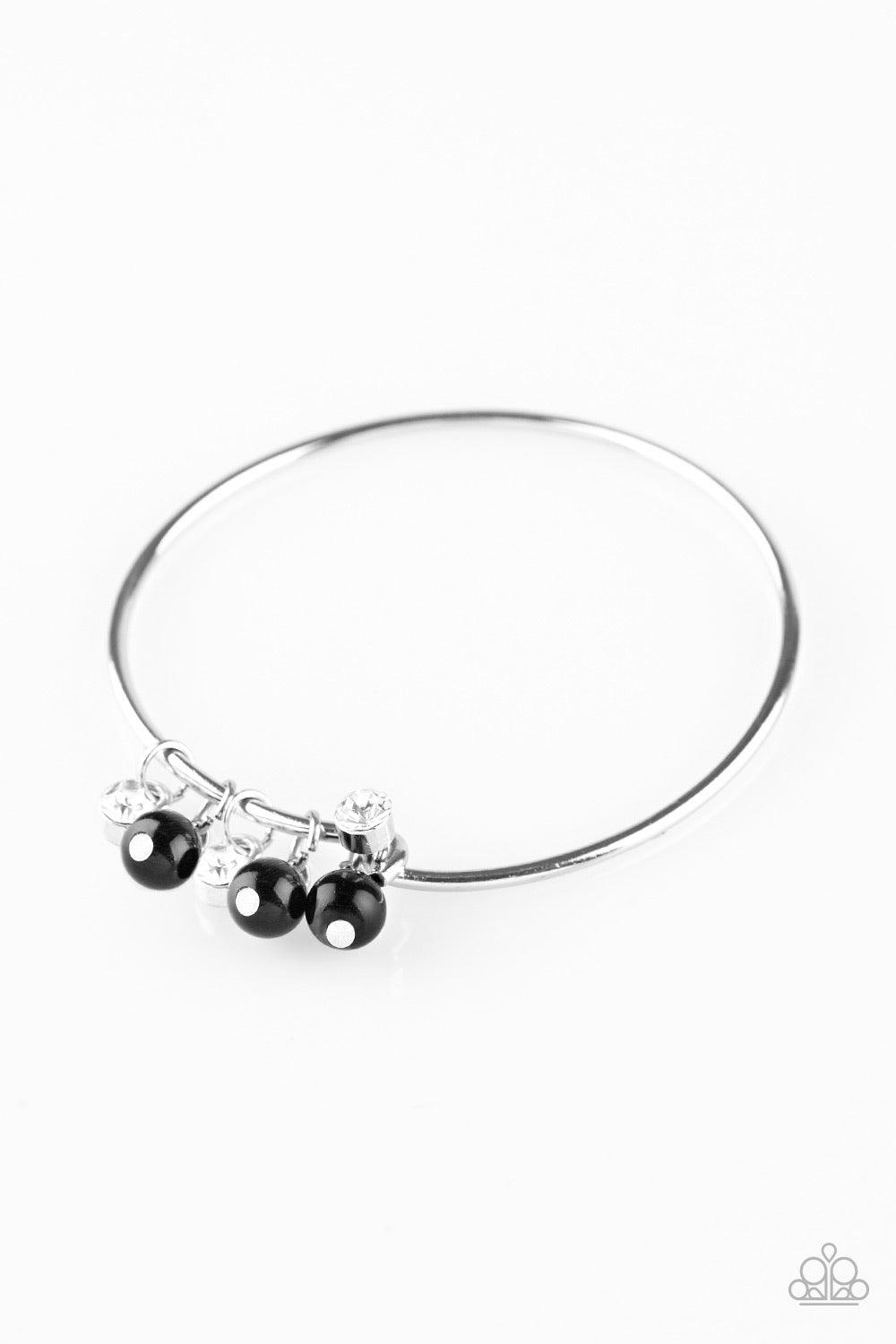 Paparazzi Accessories Marine Melody - Black Glassy black beads and glittery white rhinestones slide along a dainty silver wire infused with a rhinestone encrusted fitting, creating a versatile adjustable like bangle. Features a hinged closure. Jewelry