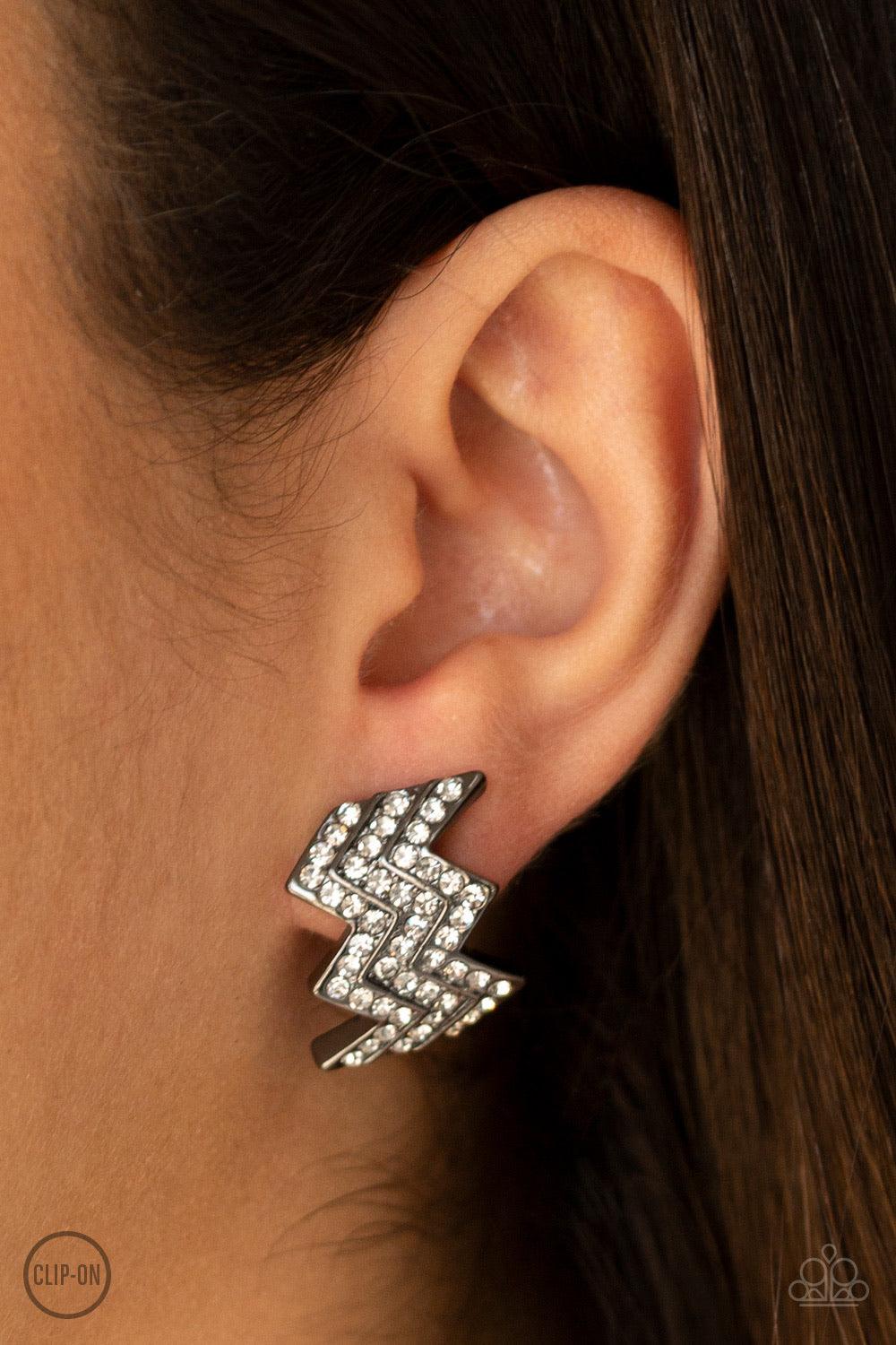 Paparazzi Accessories Fast As Lightning - Black *Clip-On Row after row of glittery white rhinestones are encrusted along a zagging gunmetal frame for an edgy glamour. Earring attaches to a standard clip-on fitting. Jewelry