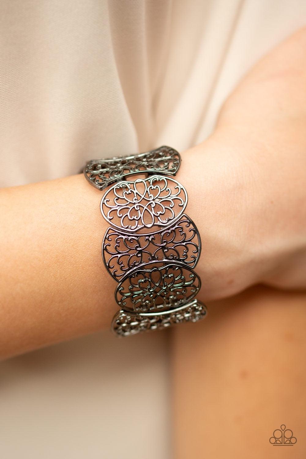 Paparazzi Accessories Fancy Fashionista - Black Filled with filigree details, a collection of gunmetal frames are threaded along stretchy bands around the wrist for a whimsical look. Jewelry