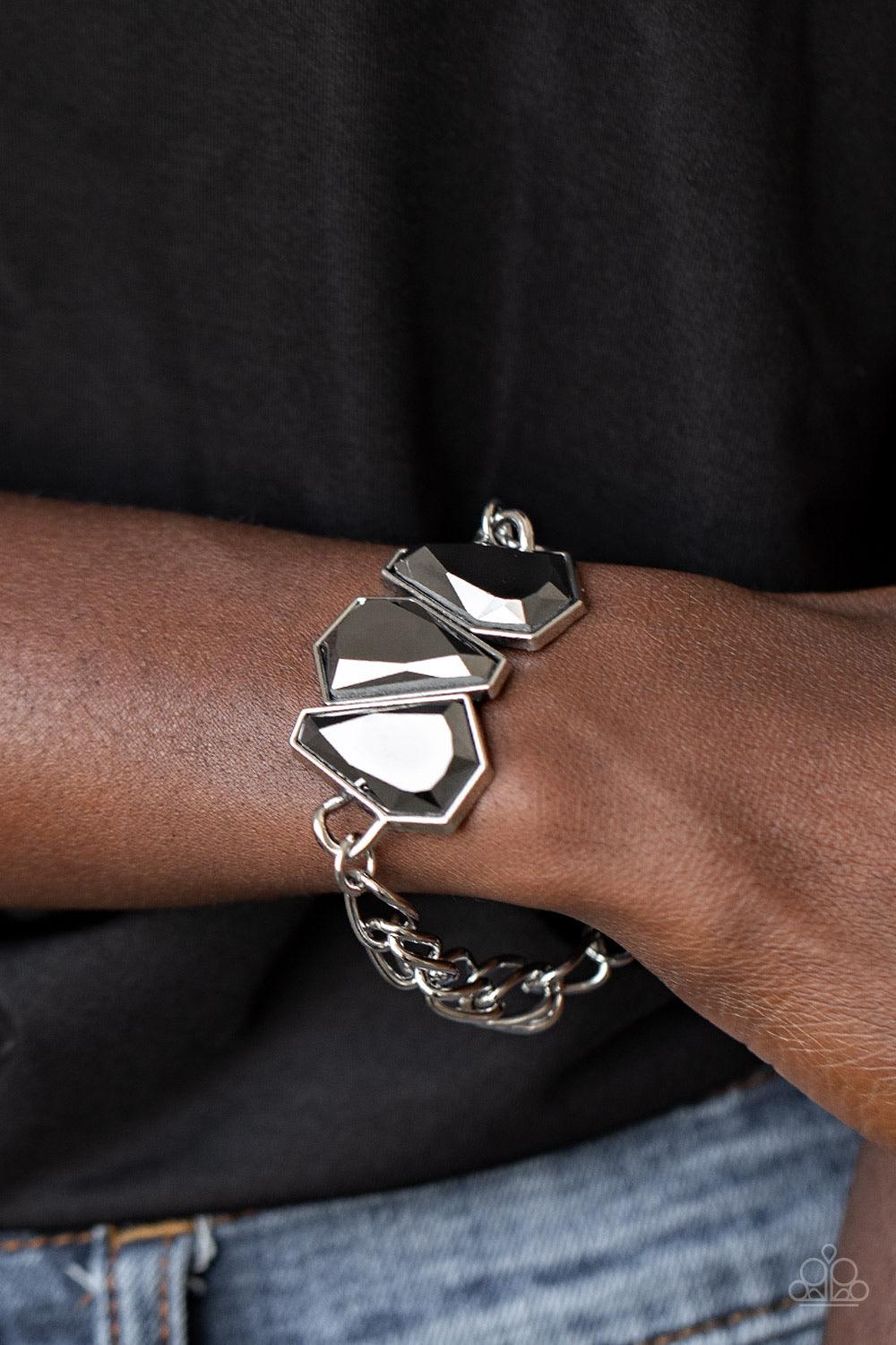 Paparazzi Accessories Raw Radiance - Silver Attached to a shiny silver chain, a trio of sparkly hematite gem-shaped rhinestones join into a glamorous centerpiece atop the wrist. Features an adjustable clasp closure. Sold as one individual bracelet. Jewelr
