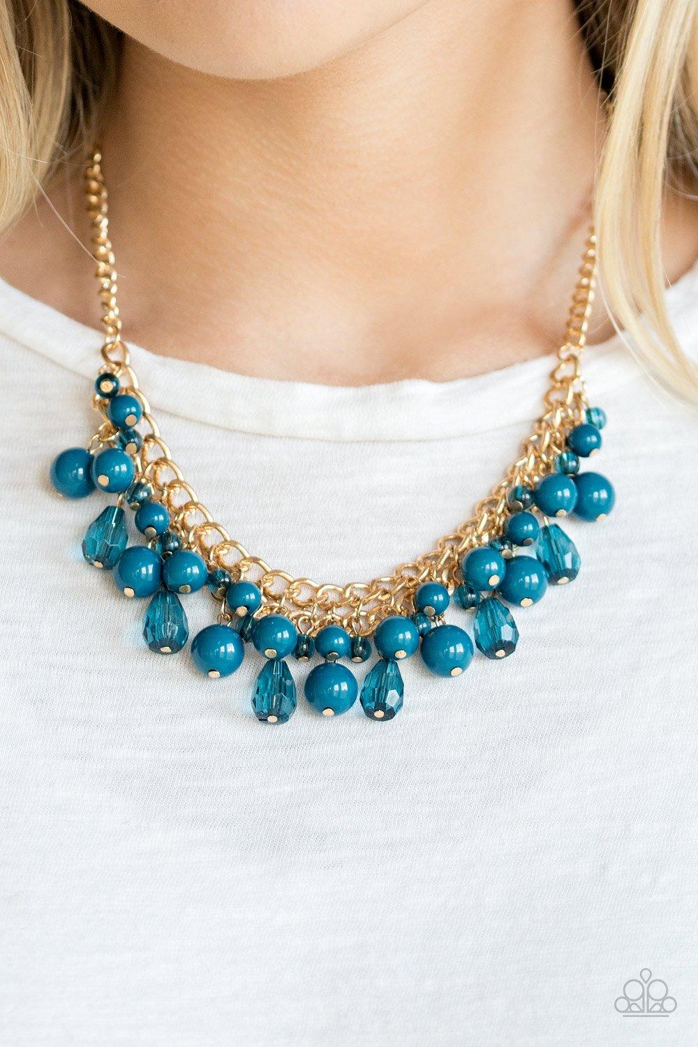 Paparazzi Accessories Tour De Trendsetter - Blue Varying in shape, glassy and polished blue beads swing from the bottom of interlocking gold chains. Crystal-like teardrops are sprinkled along the colorful beading, creating a flirtatious fringe below the c