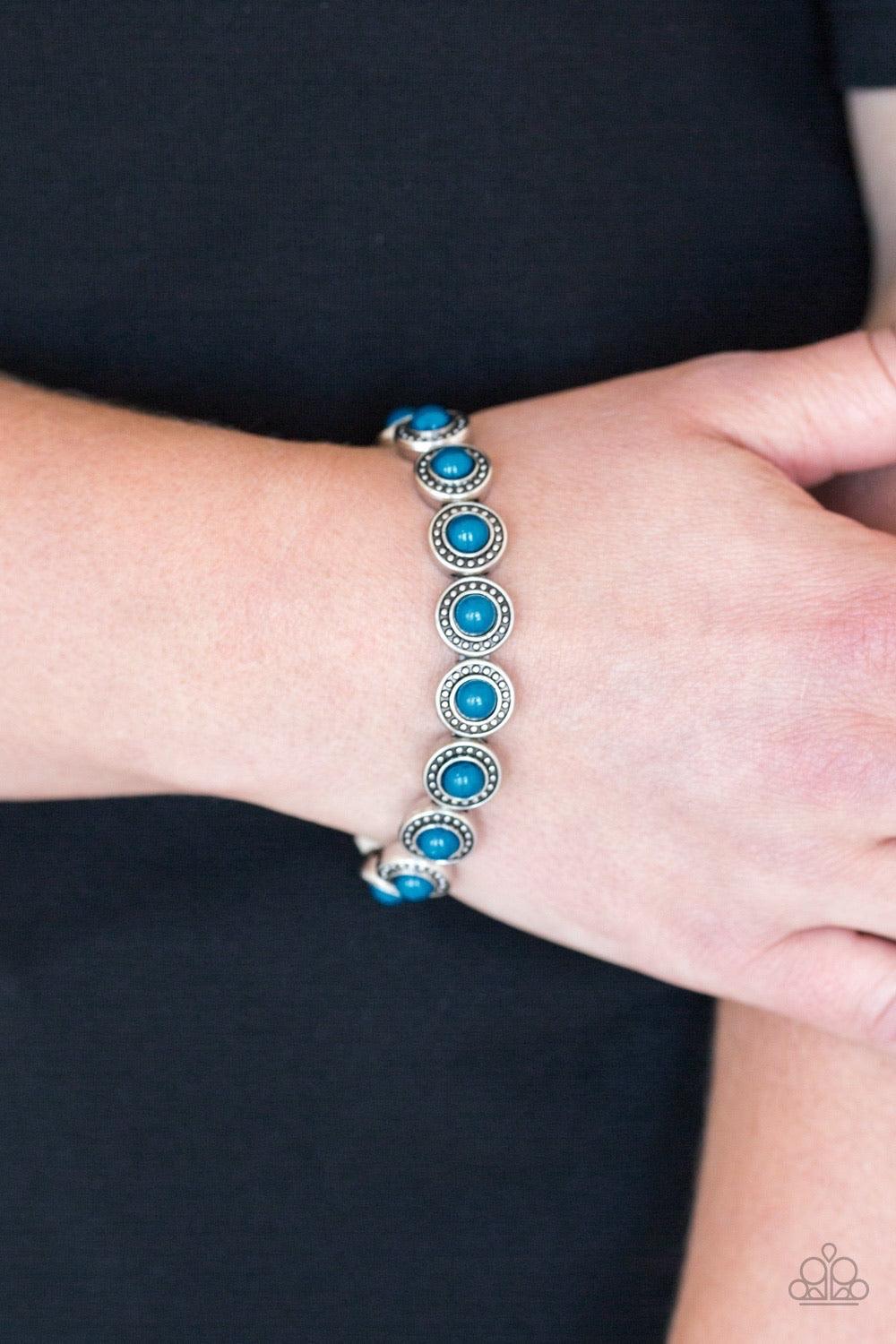 Paparazzi Accessories Globetrotter Goals - Blue Dotted with refreshing blue beaded centers, studded silver frames are threaded along stretchy elastic bands and linked around the wrist for a whimsical look. Jewelry