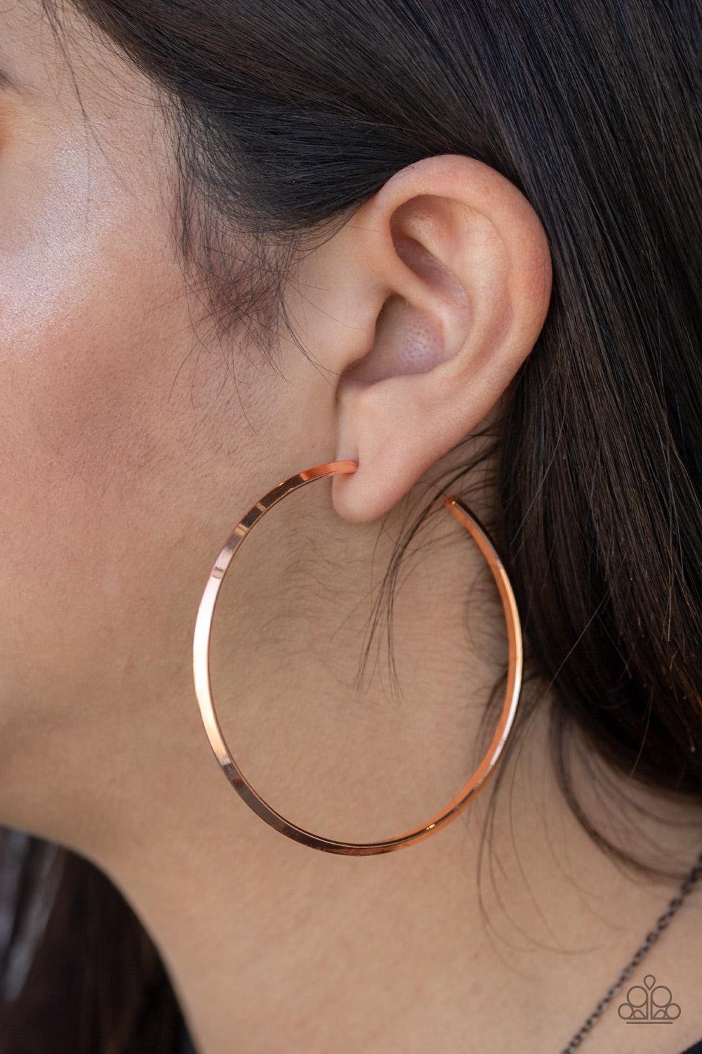 Paparazzi Accessories 5th Avenue Attitude - Copper Brushed in an antiqued shimmer, a glistening copper bar curls into a sleek hoop for a classic look. Earring attaches to a standard post fitting. Hoop measures 2 1/2" in diameter. Jewelry