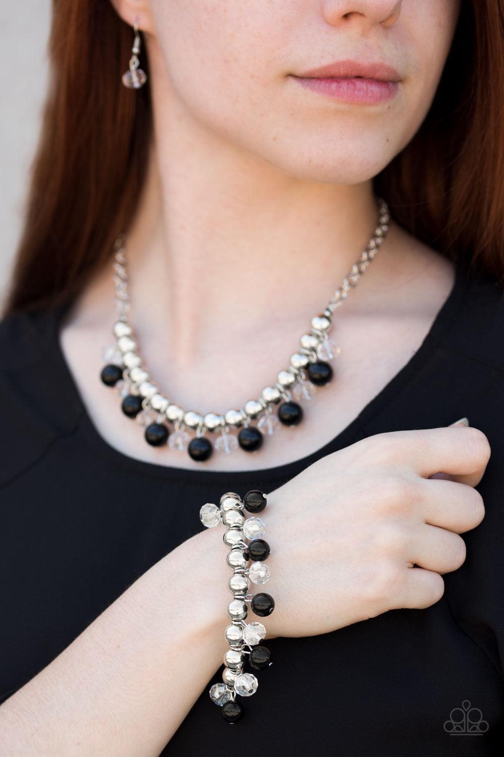 Paparazzi Accessories Once In A Millennium - Black Shiny silver beads are threaded along an elastic stretchy band. Shiny black beads and glassy crystal-like beads swing from the wrist for a refined look. Sold as one individual bracelet. Jewelry