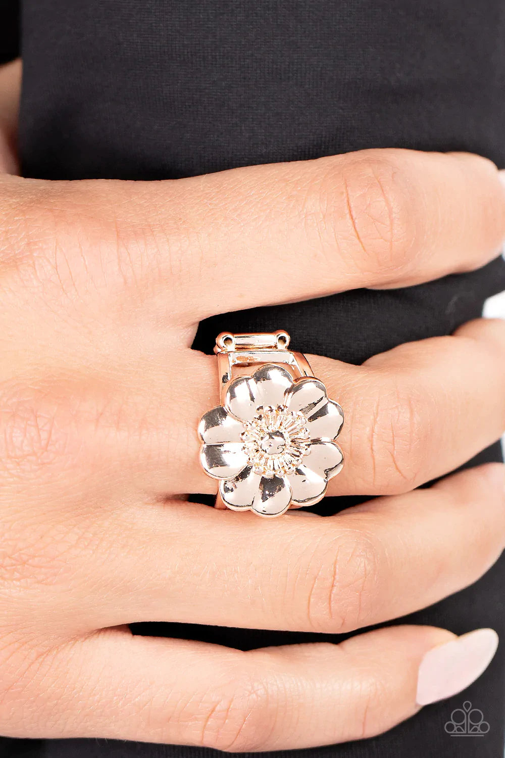 Paparazzi Accessories Floral Farmstead - Rose Gold Folds of heart shaped rose gold petals gather around a pronged and studded center, blooming into a whimsical floral centerpiece atop the finger. Features a stretchy band for a flexible fit. Sold as one in