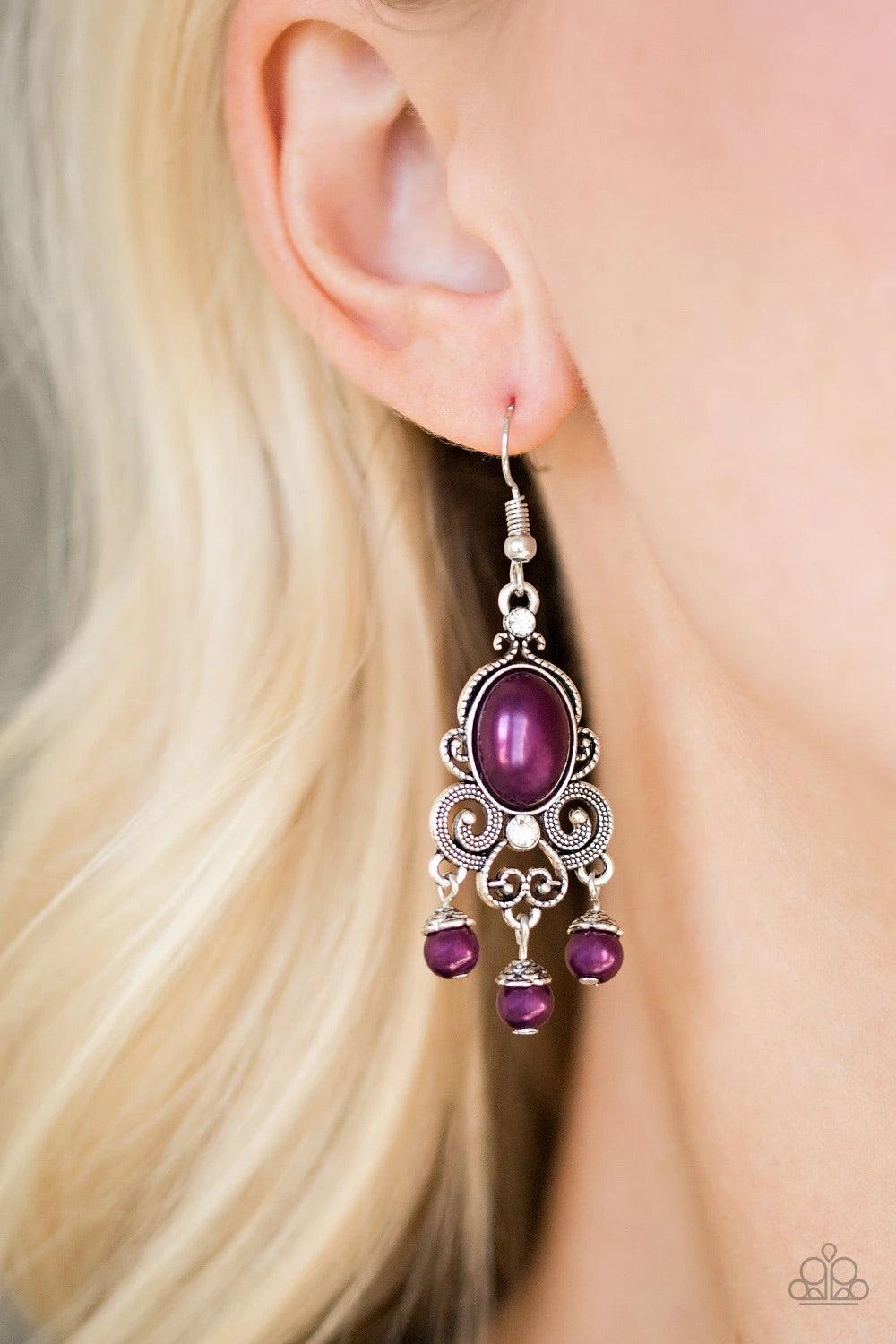 Paparazzi Accessories I Better Get GLOWING - Purple Dotted silver filigree spins around a pearly purple bead and dainty white rhinestones, coalescing into a regal frame. A pearly fringe swings from the bottom of the frame for a refined finish. Earring att