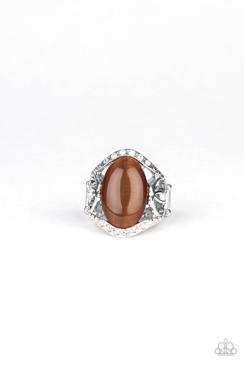 Paparazzi Accessories Dew Onto Others - Brown A dewy brown cat's eye stone is pressed into the center of an ornate silver frame dotted in sections of glassy white rhinestones, creating a whimsical centerpiece atop the finger. Features a stretchy band for