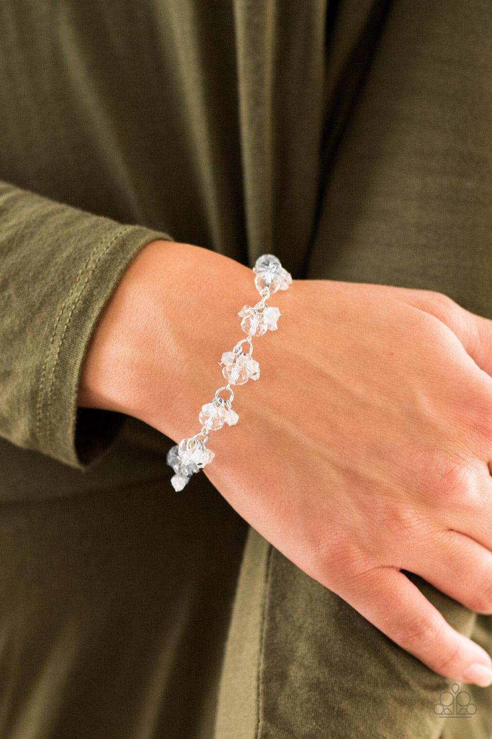 Paparazzi Accessories Oh, My Stars - White Glassy and faceted white crystal beading trickles along a silver chain, creating a dramatic fringe around the wrist. Featuring elegant pear-shaped cuts, iridescent crystals cluster atop the glassy gems for an inc