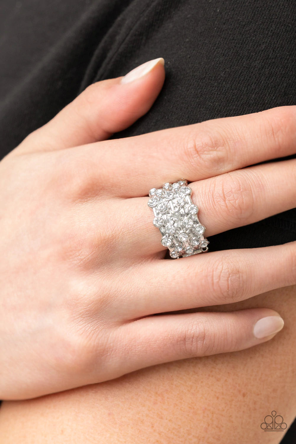 Paparazzi Accessories Metro Motivation- White Sparkling white rhinestones encased in silver frames line up in layers across shiny silver bands creating a shimmering statement atop the finger. Features a stretchy band for a flexible fit. Sold as one indivi