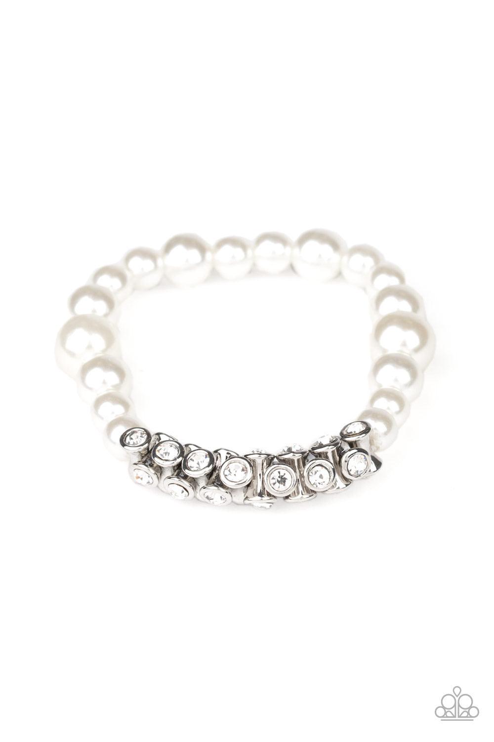 Paparazzi Accessories Traffic-Stopping Sparkle - White A collection of white pearls and white rhinestone dotted silver frames are threaded along stretchy bands around the wrist, creating a sparkling centerpiece. Sold as one individual bracelet. Jewelry