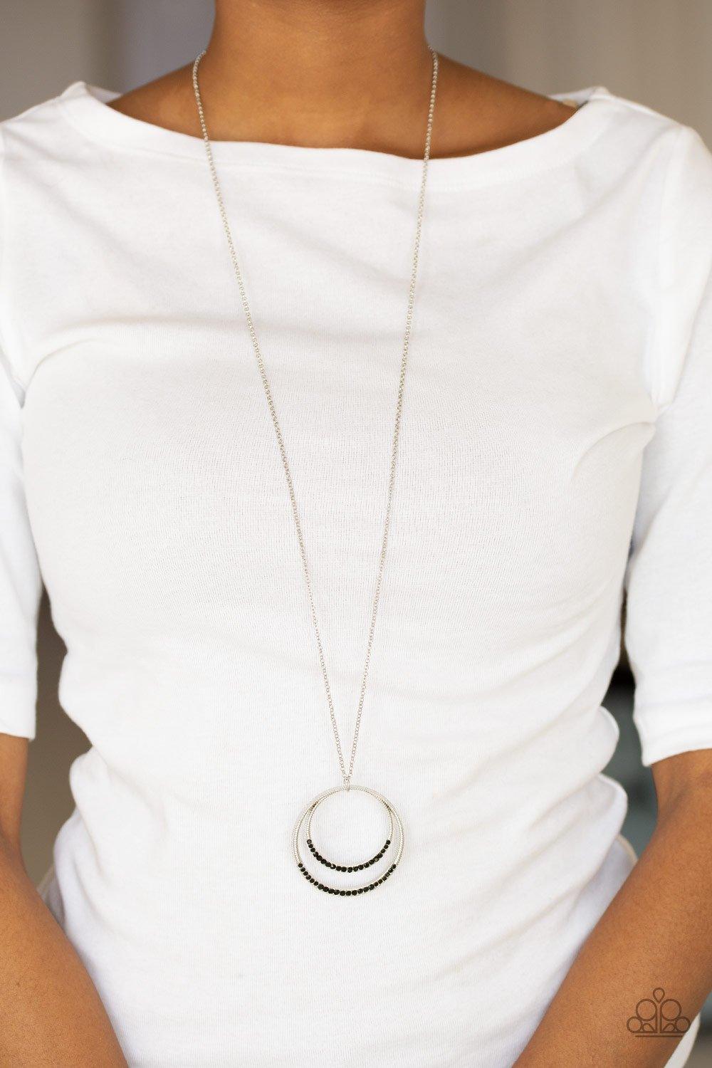Paparazzi Accessories Front and EPICENTER - Black A daring circular pendant swings from the bottom of an elongated silver chain for a refined look. The bottoms of the ornate silver pendant are encrusted in black rhinestones for a glamorous finish. Feature