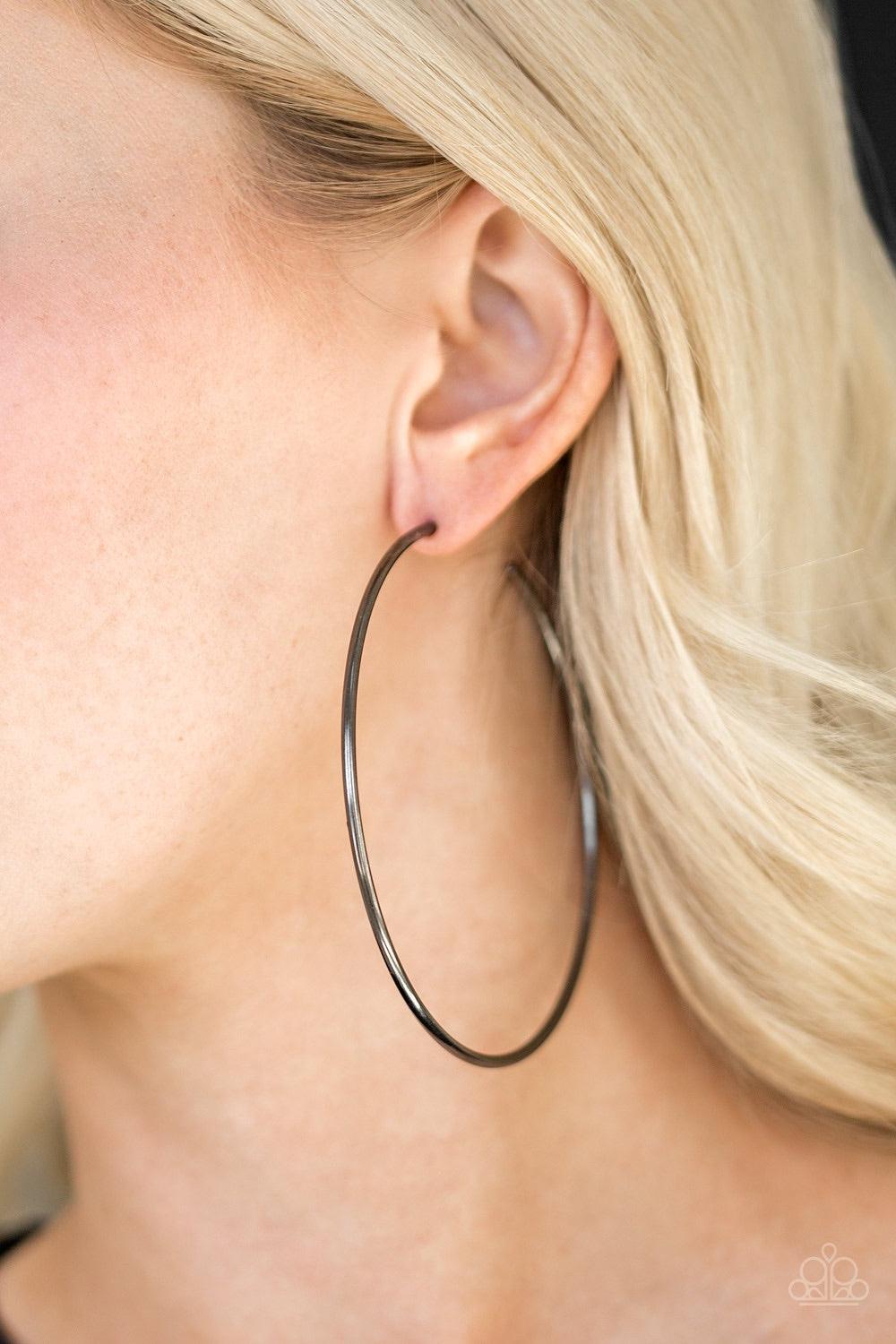 Paparazzi Accessories Meet Your Maker - Black A skinny ribbon of gunmetal curls into a bold hoop for a dramatic look. Earring attaches to a standard post fitting. Hoop measures 3โ in diameter. Jewelry