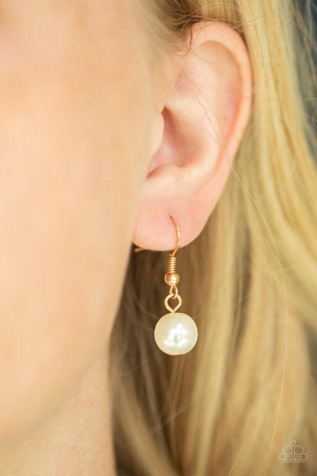 Paparazzi Accessories Behind The Scenes - Gold A collection of dainty and classic white pearls link across the chest in a timeless fashion. Features an adjustable clasp closure. Jewelry