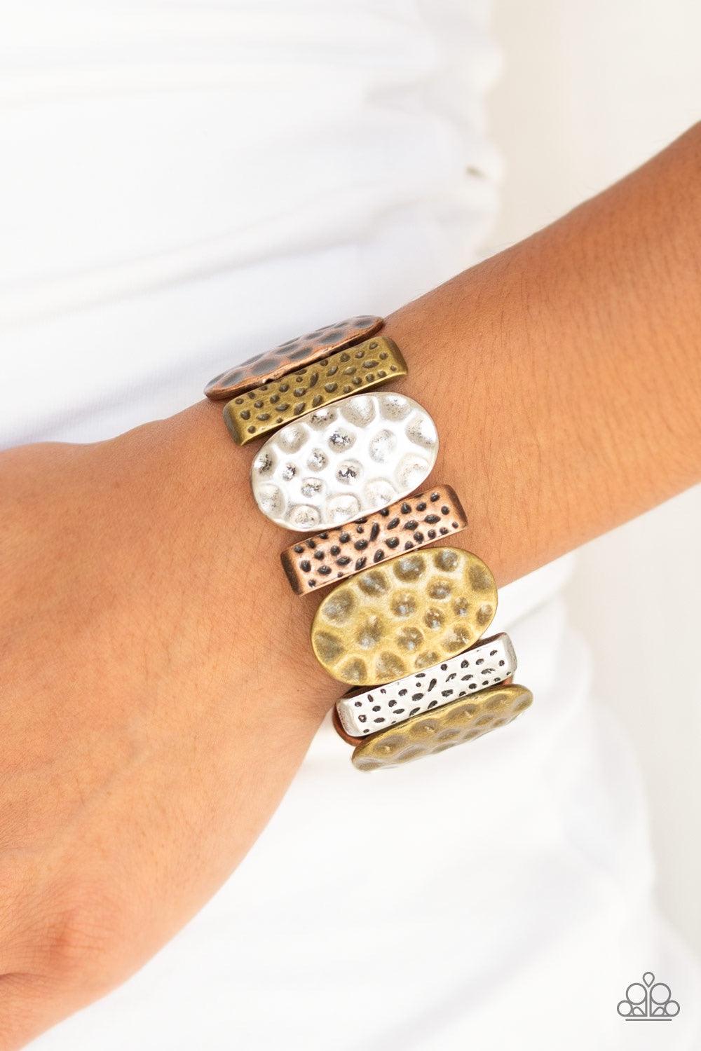Paparazzi Accessories Cave Cache - Multi Delicately hammered in antiqued detail, round and rectangular shaped frames are threaded along stretchy bands, creating a bold tribal look around the wrist. Jewelry