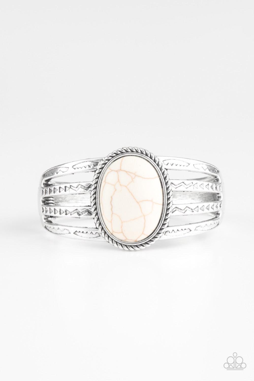 Paparazzi Accessories Desert Glyphs - White Stamped in tribal glyph-like patterns, glistening silver bars arc across the wrist, coalescing into a bold cuff-like bracelet. An earthy white stone is pressed into the center of the piece for a seasonal finish.