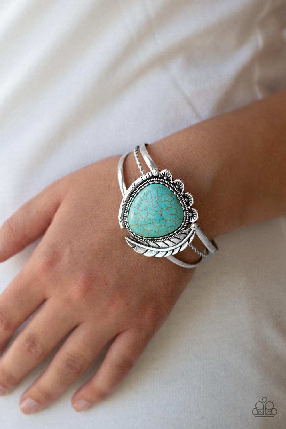 Paparazzi Accessories Natures Bounty - Blue Chiseled into a tranquil teardrop shape, a refreshing turquoise stone is pressed into the center of a layered silver cuff. Stamped in tribal inspired patterns, mismatched silver frames and an antiqued silver fea