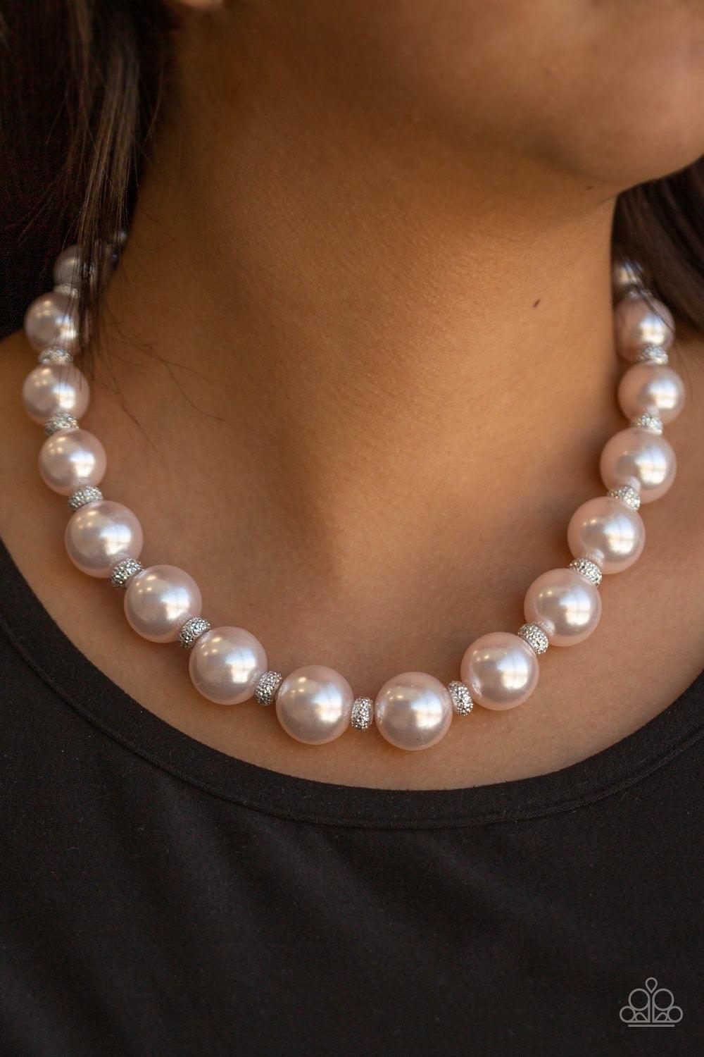 Paparazzi Accessories Uptown Heiress ~Pink Infused with dainty silvery rhinestone encrusted beads, a refined collection of over sized pink pearls are threaded along an invisible wire below the collar for timeless dazzle. Features an adjustable clasp closu