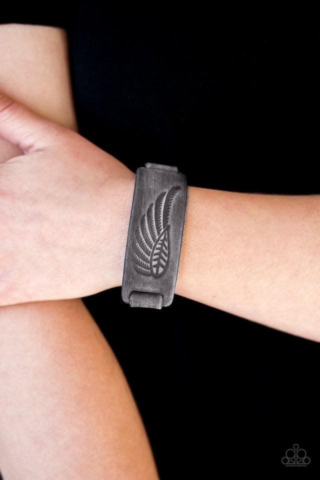 Paparazzi Accessories Backwoods Roamer - Silver Brushed in a distressed finish, a gray suede band is stamped in an earthy leaf and feather pattern for a seasonal look. Features an adjustable snap closure. Jewelry