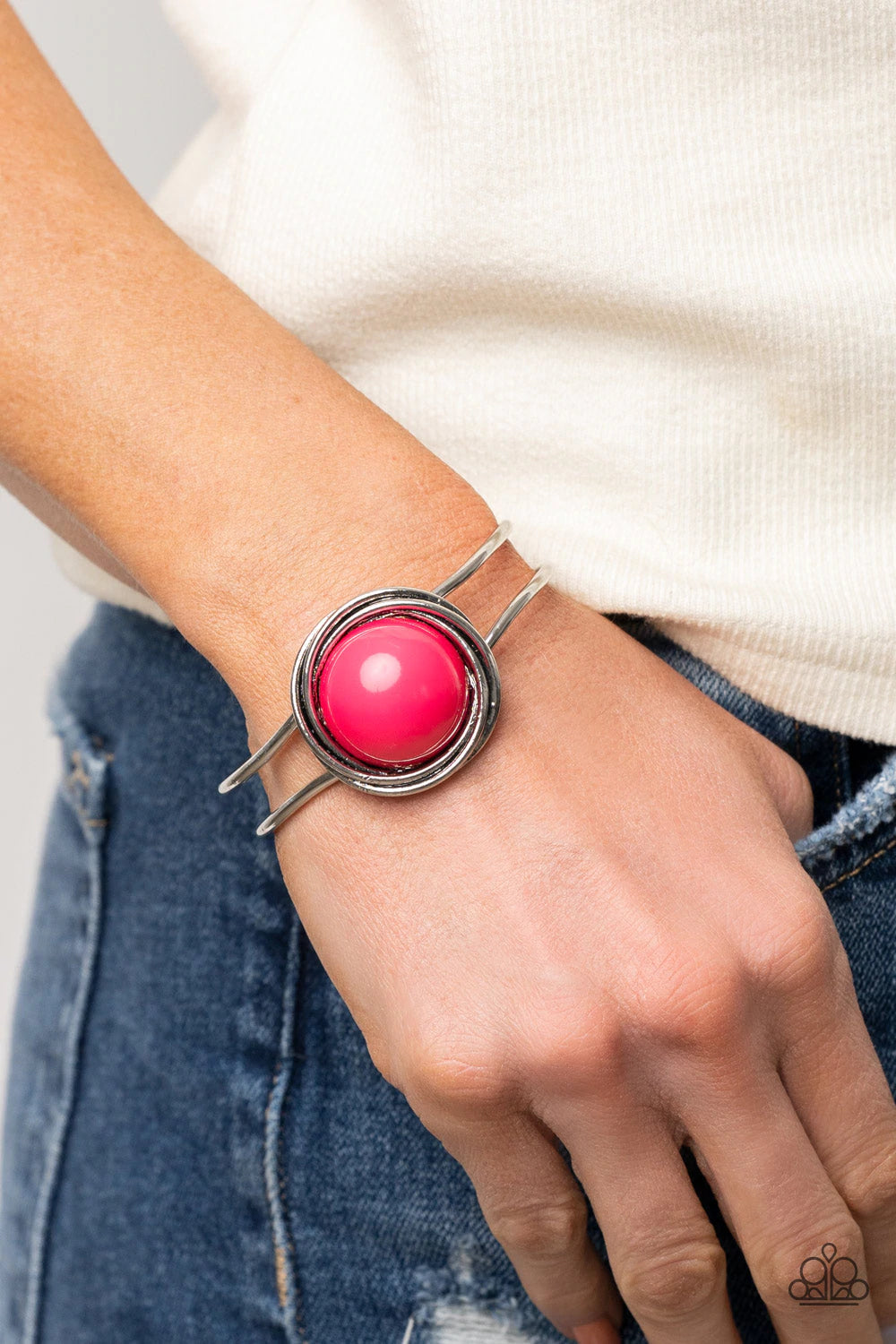 Paparazzi Accessories Take It From The POP! - Pink An oversized Raspberry Sorbet bead is pressed into the center of overlapping silver rings that coalesce into a dizzying centerpiece atop an airy silver bangle-like cuff, creating a bold pop of color atop