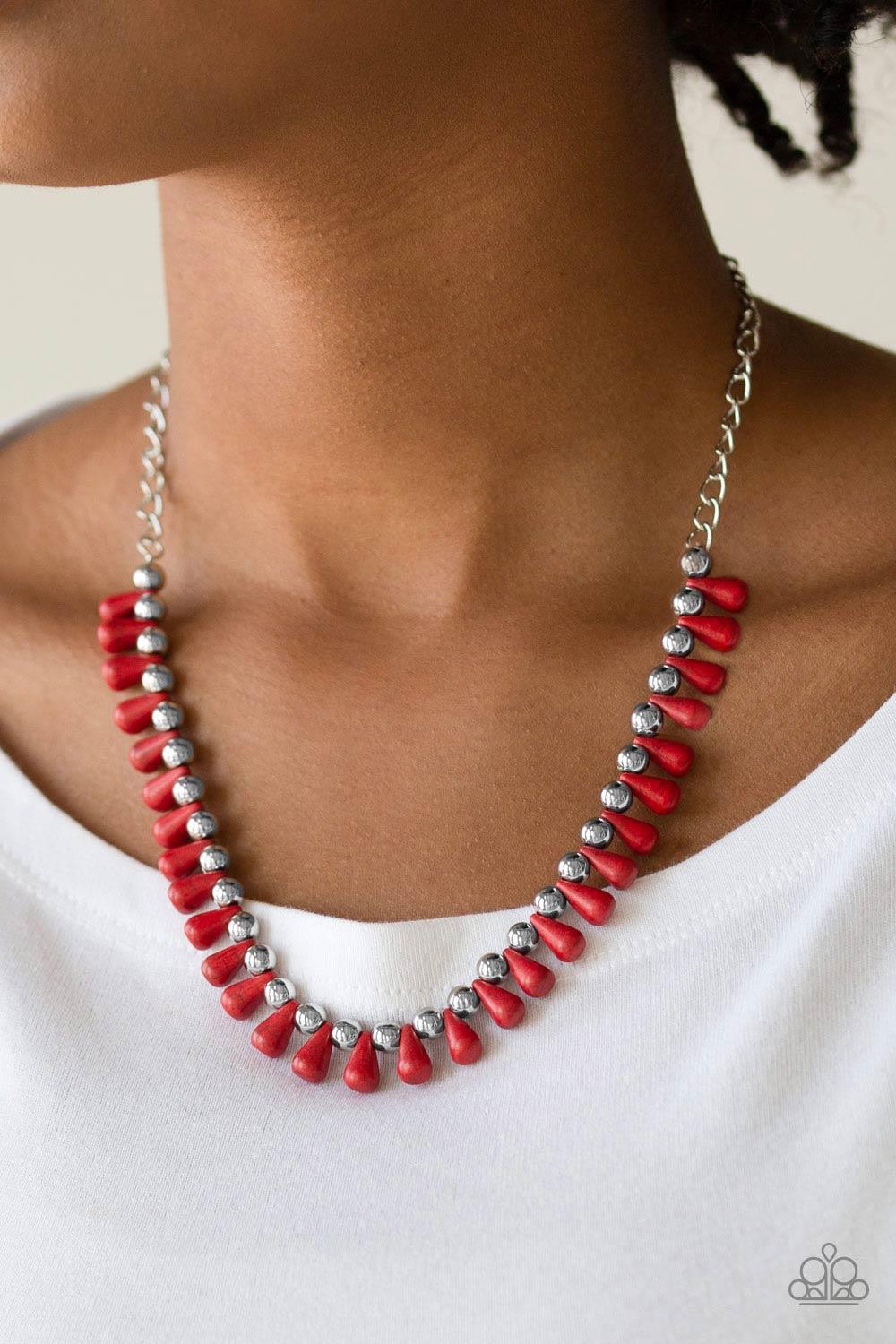 Paparazzi Accessories Extinct Species - Red Red teardrop stones and classic silver beads are threaded along an invisible wire. The earthy beads alternate below the collar, creating a wild fringe. Features an adjustable clasp closure. Sold as one individua