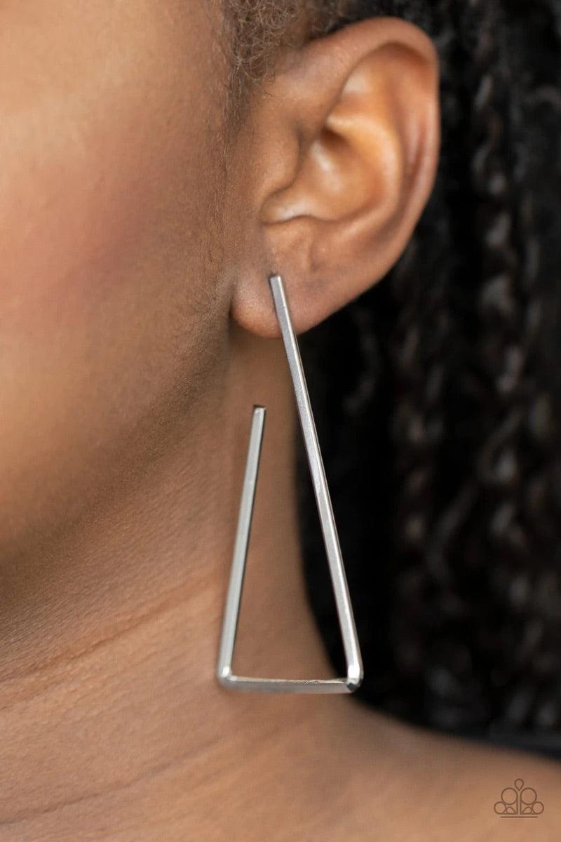 Paparazzi Accessories Go Ahead and Tri - Silver A glistening silver bar sharply bends into an airy triangular frame for an edgy geometric look. Earring attaches to a standard post fitting. Hoop measures approximately 2" in diameter. Sold as one pair of ho