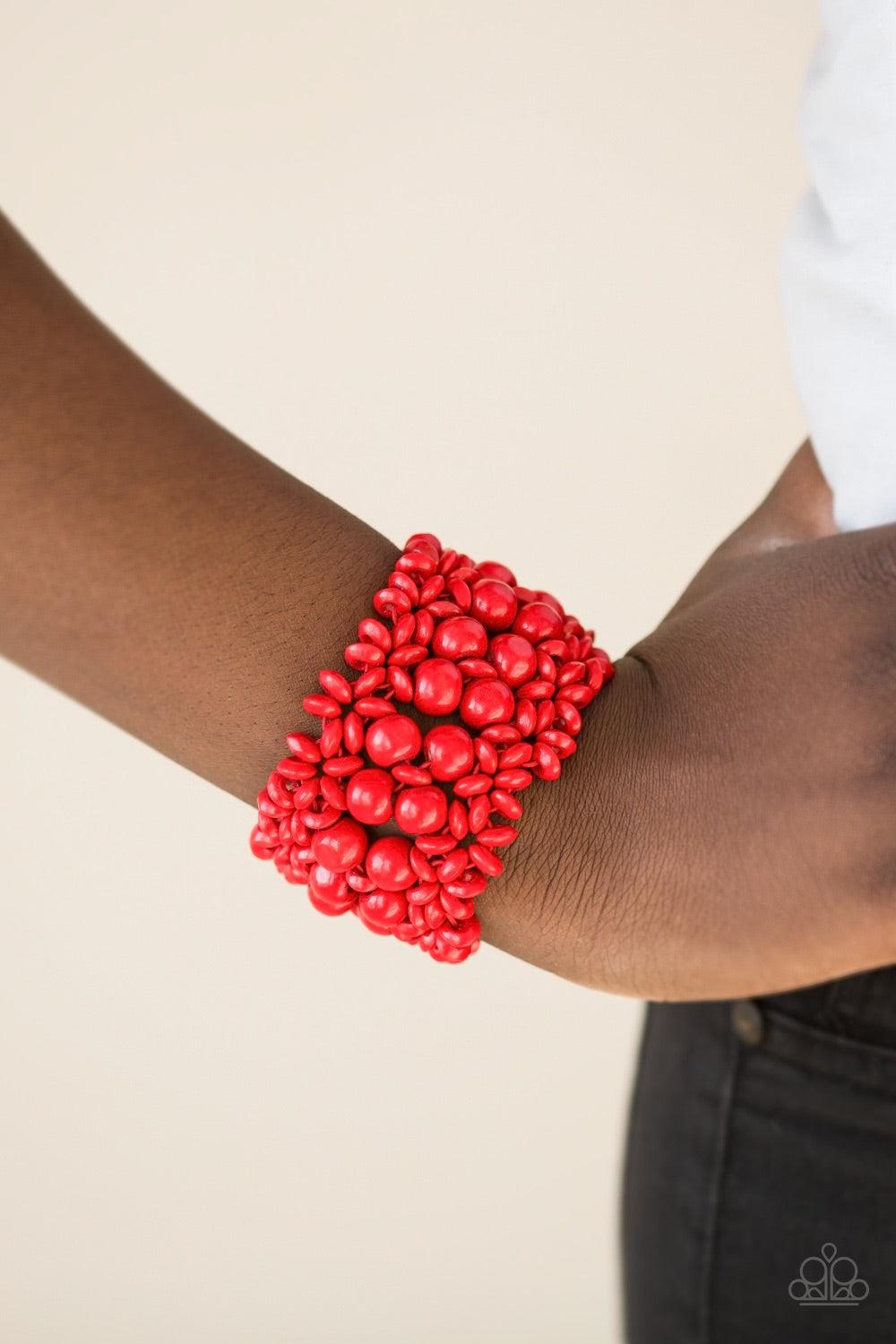 Paparazzi Accessories Tropical Bliss - Red Red wooden accents are threaded along elastic stretchy bands, creating an ornate bracelet. Rounded red wooden beads line the center of the summery pattern for a bold finish. Jewelry