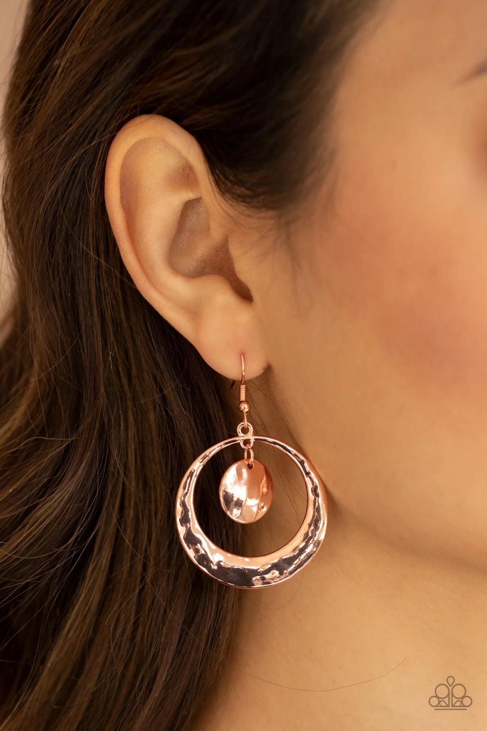 Paparazzi Accessories Rounded Radiance - Copper A hammered shiny copper disc swings from the top of a hammered shiny copper hoop that widens at the bottom, creating a radiant lure. Earring attaches to a standard fishhook fitting.Sold as one pair of earrin