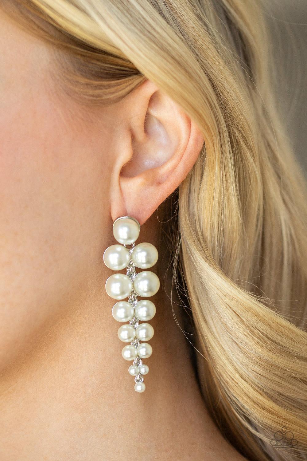 Paparazzi Accessories Totally TriBeCa - White Gradually decreasing in size, pairs of classic white pearls drip from a solitaire pearl, coalescing into a dramatic triangular-shaped lure. Earring attaches to a standard post fitting. Jewelry