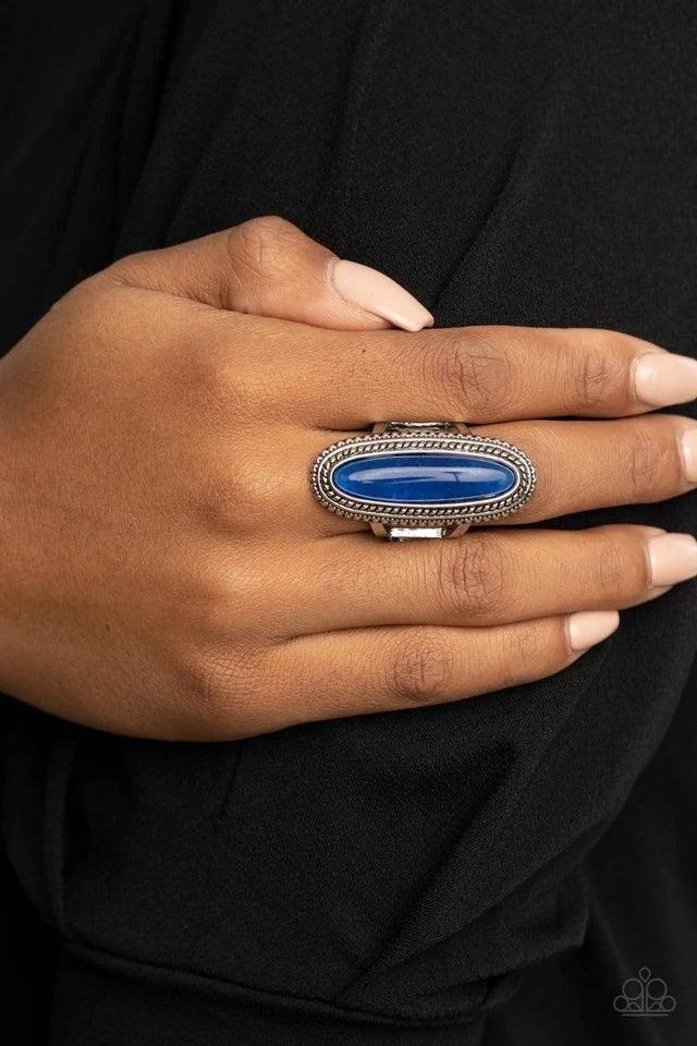 Paparazzi Accessories Stone Healer - Blue An oblong lapis lazuli stone is pressed into the center of a textured silver frame, dramatically dipping down the finger for a statement making stone fashion. Features a stretchy band for a flexible fit. Sold as o