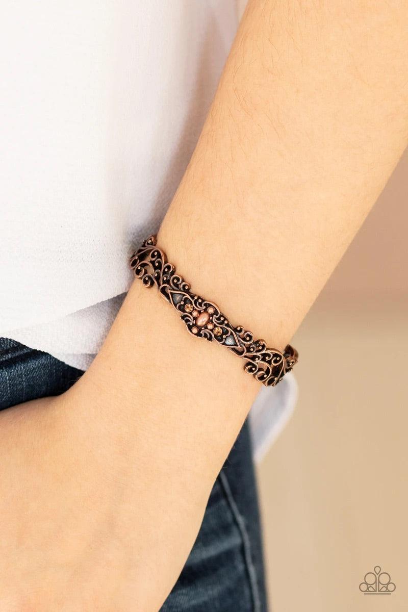 Paparazzi Accessories Victorian Vines ~ Copper Brushed in an antiqued finish, copper filigree vines across the wrist, coalescing into a delicate cuff. Dainty topaz rhinestones and pearly copper beads adorn the center of the cuff for a whimsical finish. So