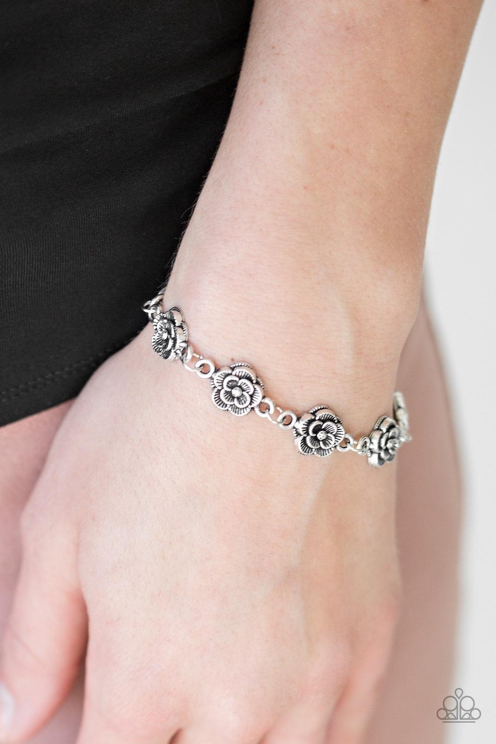 Paparazzi Accessories Wildflower Wonderland - Silver Brushed in an antiqued shimmer, dainty silver blossoms link across the wrist for a whimsical fashion. Features an adjustable clasp closure. Jewelry