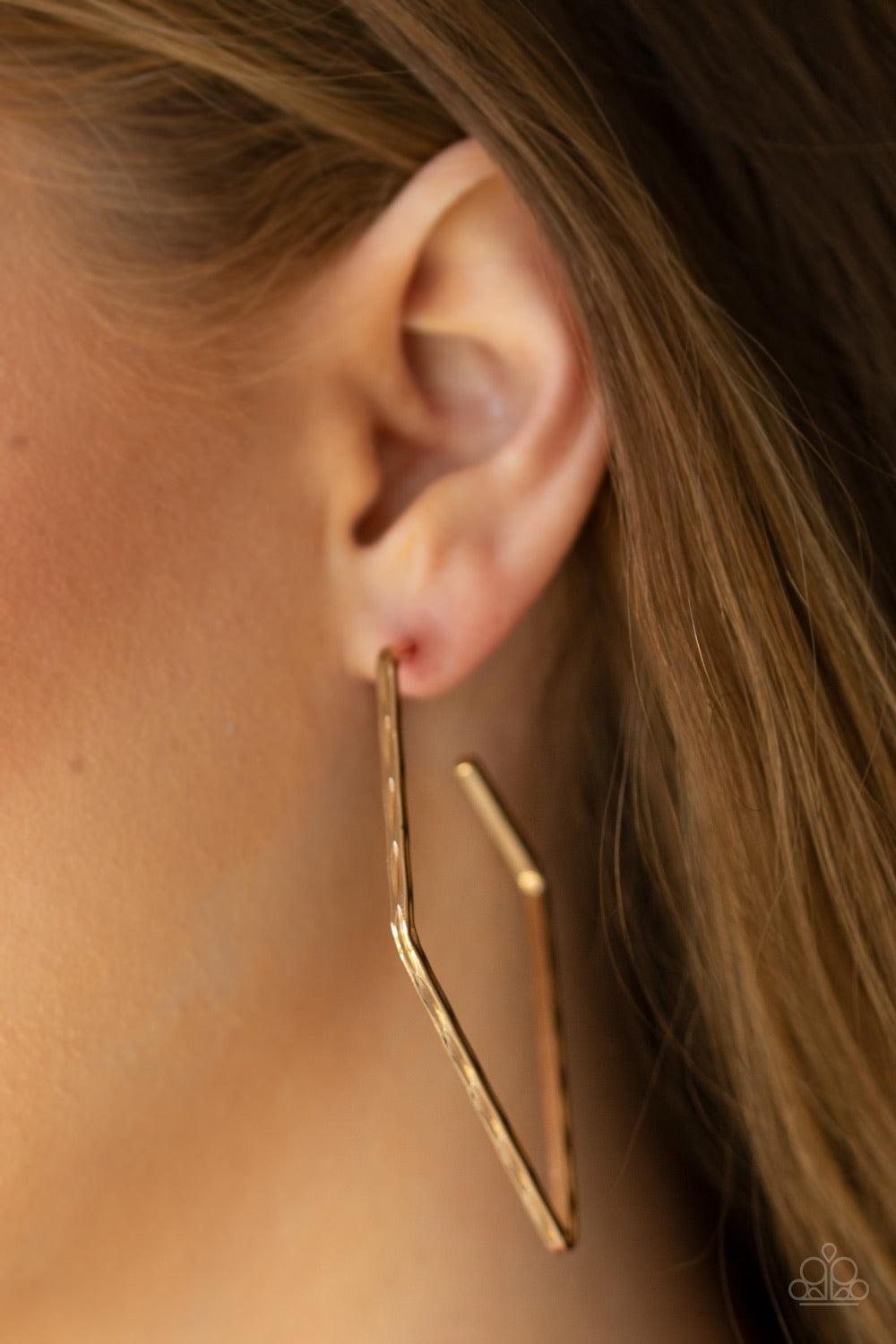 Paparazzi Accessories Geo Grunge - Gold Delicately hammered in endless shimmer, a glistening gold bar bends into an edgy kite-like hoop for a radical fashion. Earring attaches to a standard post fitting. Hoop measures approximately 1 3/4" in diameter. Jew