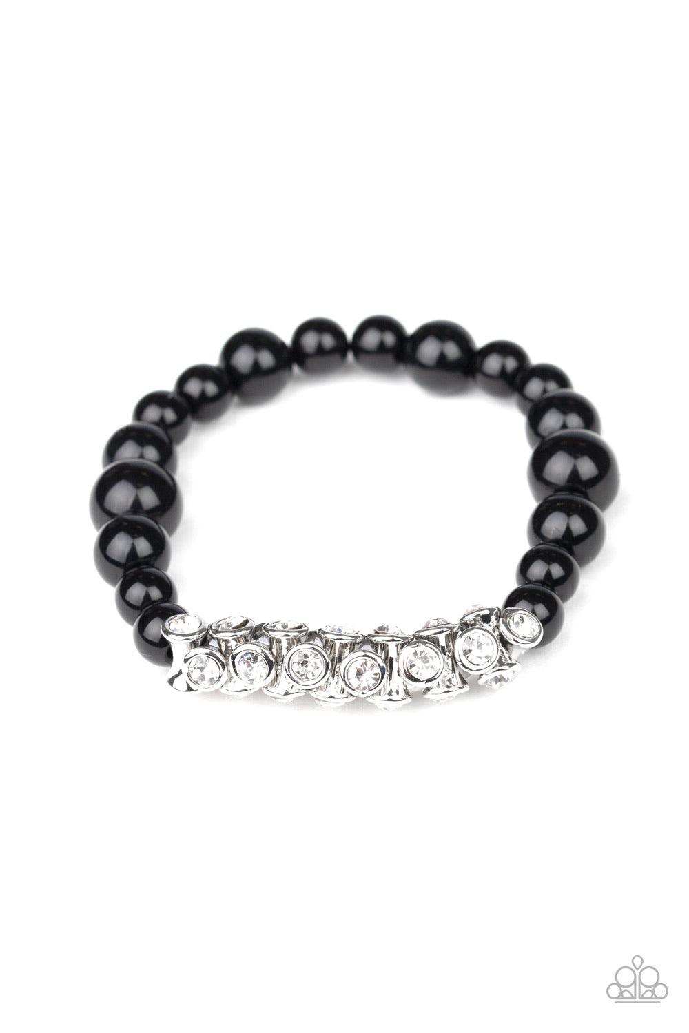 Paparazzi Accessories Traffic Stopping Sparkle - Black A collection of black beads and white rhinestone dotted silver frames are threaded along a stretchy band around the wrist, creating a sparkling centerpiece. Sold as one individual bracelet. Jewelry